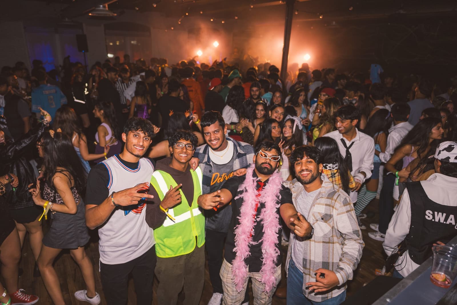 A packed campus crowd gathered under warm event lighting